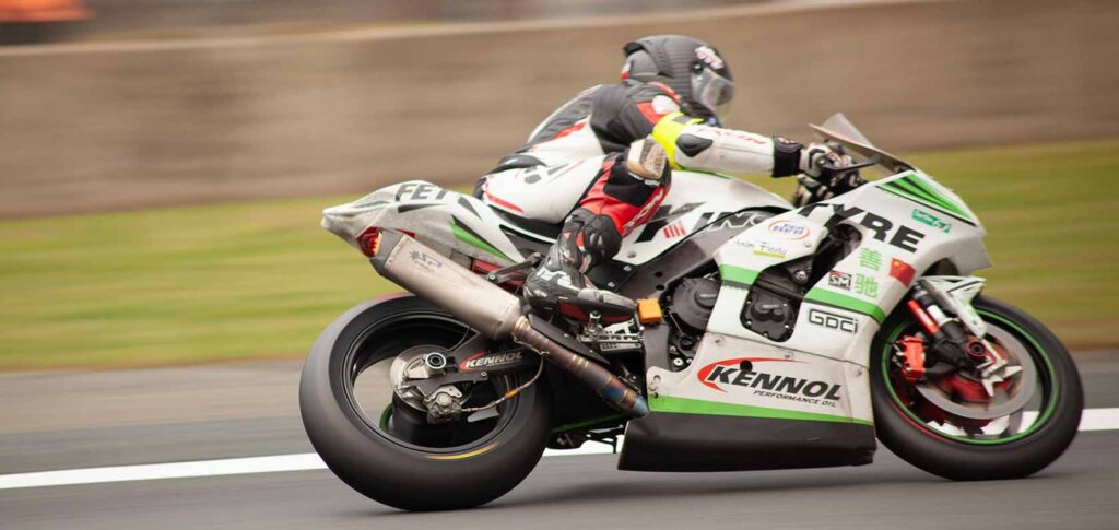 Close-up view of Kingtyre racing slick motorcycle tire on racetrack.