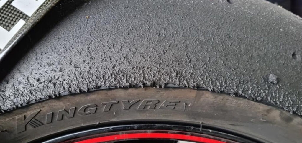 Side-by-side comparison of slick tires and street motorcycle tires